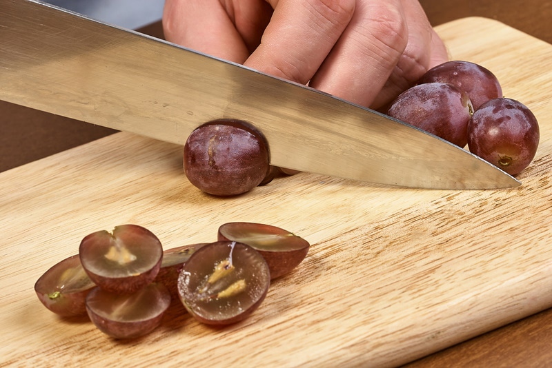sliced grapes on cutting board