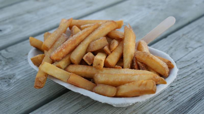 french fries served on a wooden table