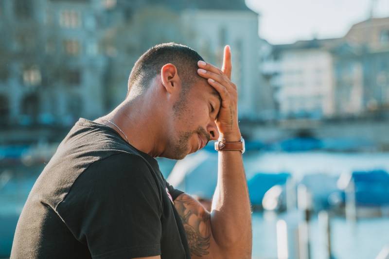 man having a headache outdoors