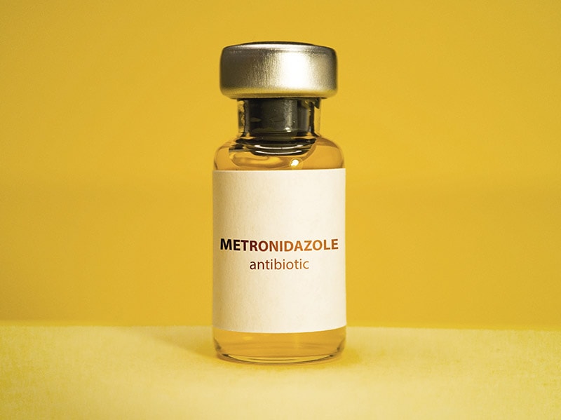 Metronidazole vial on yellow background