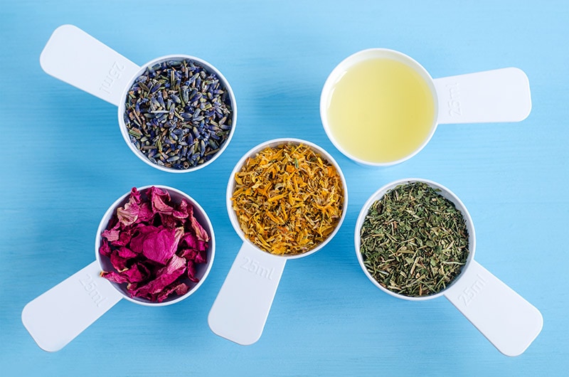 plastic scooper filled with herbal ingredients for ayurveda