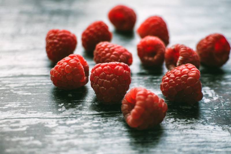 scattered raspberry pieces on the table