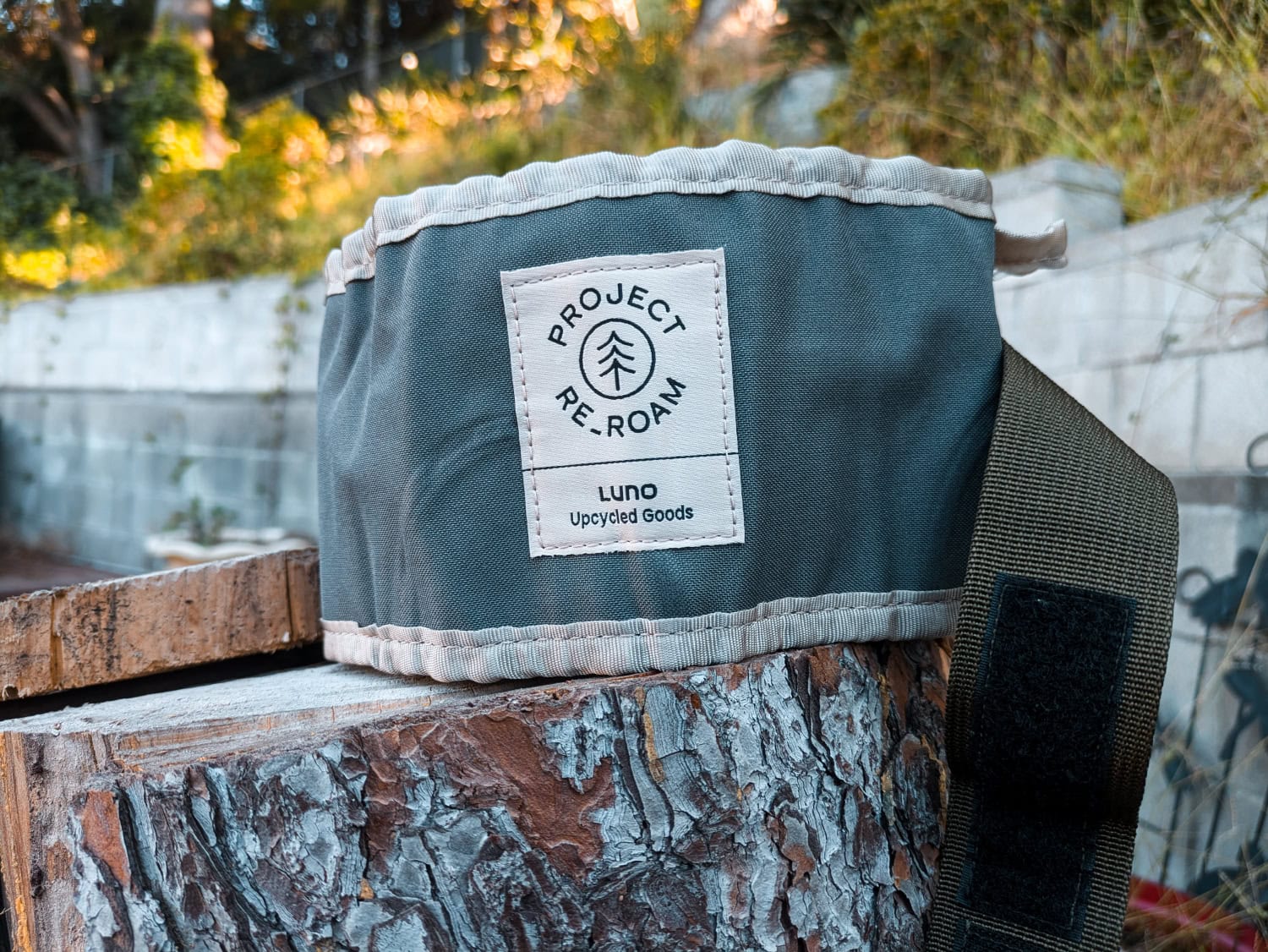 Luno Collapsible Dog Bowl - product on a log