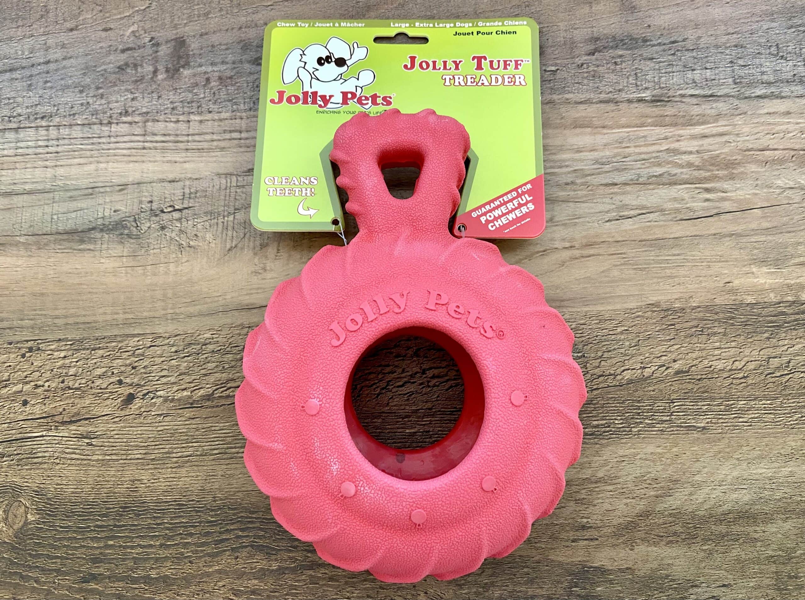 Jolly Pets Dog Toy on wooden background