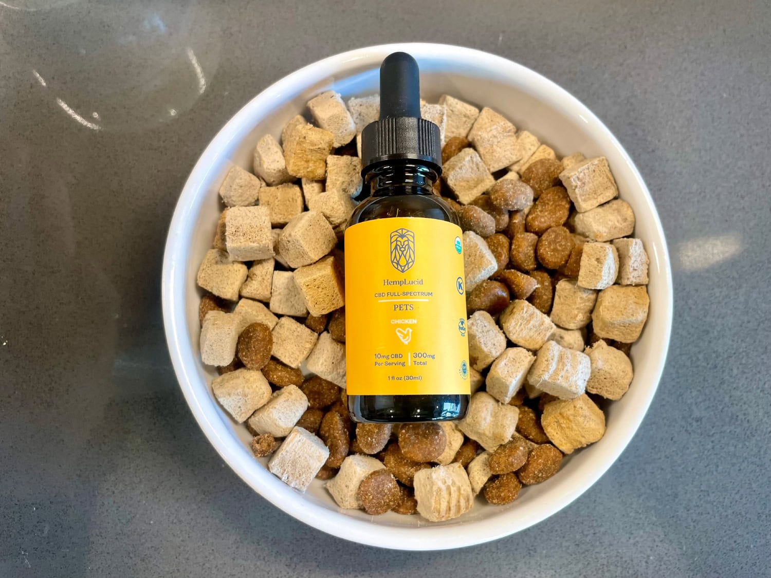 HempLucid Organic Full-Spectrum CBD - bottle on a bowl of dog food