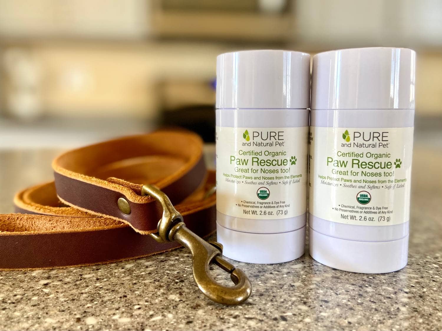 Pure and Natural Pet Paw Rescue Review - paw balms on counter with leash